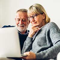 older couple looking at a laptop