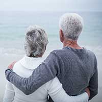 couple looking off to distance on a beach